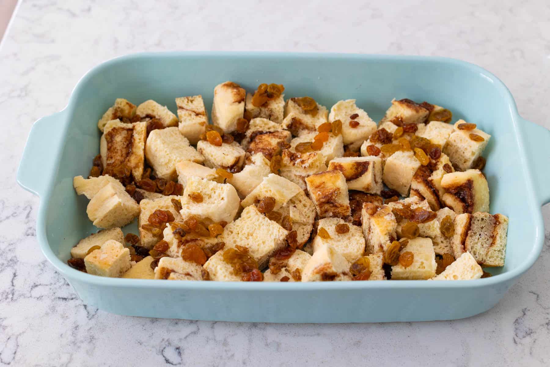 The cinnamon rolls fill the baking dish.