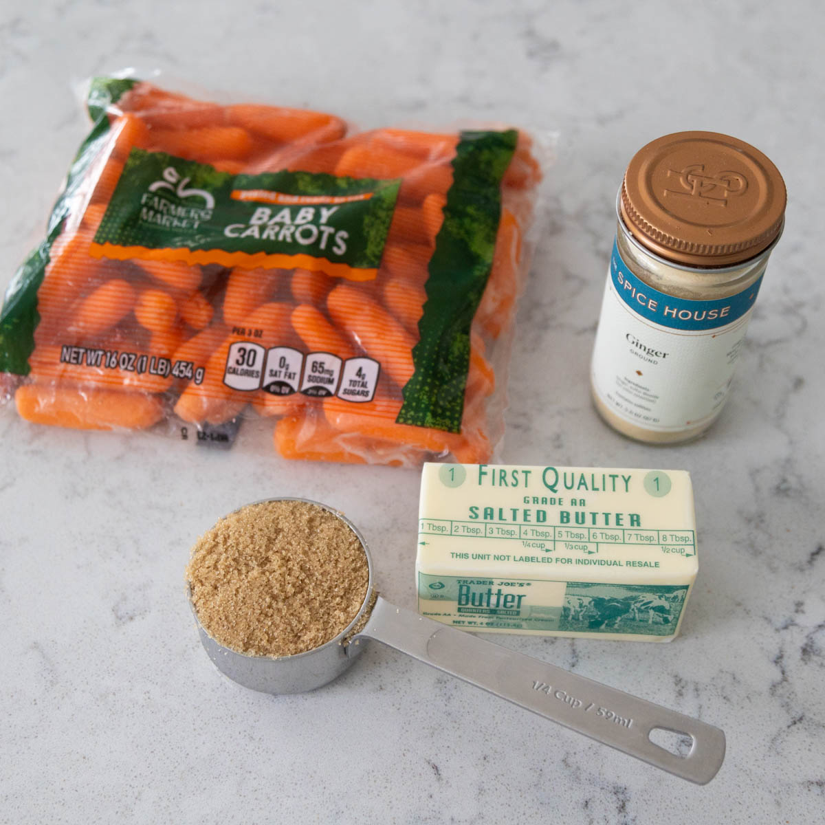 The bag of baby carrots sits next to the butter, brown sugar, and a jar of ginger.