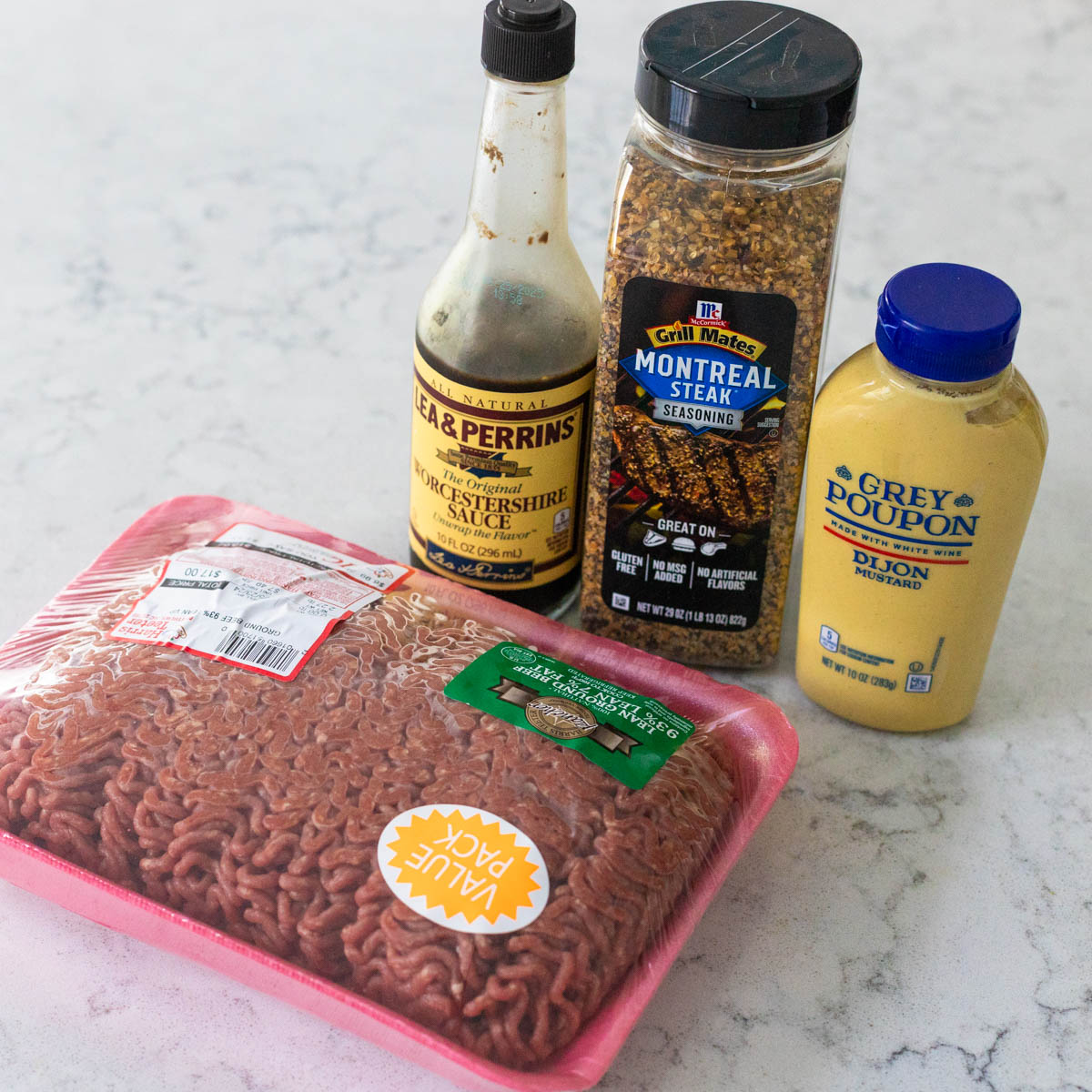 The ingredients to make a classic hamburger are on the counter.
