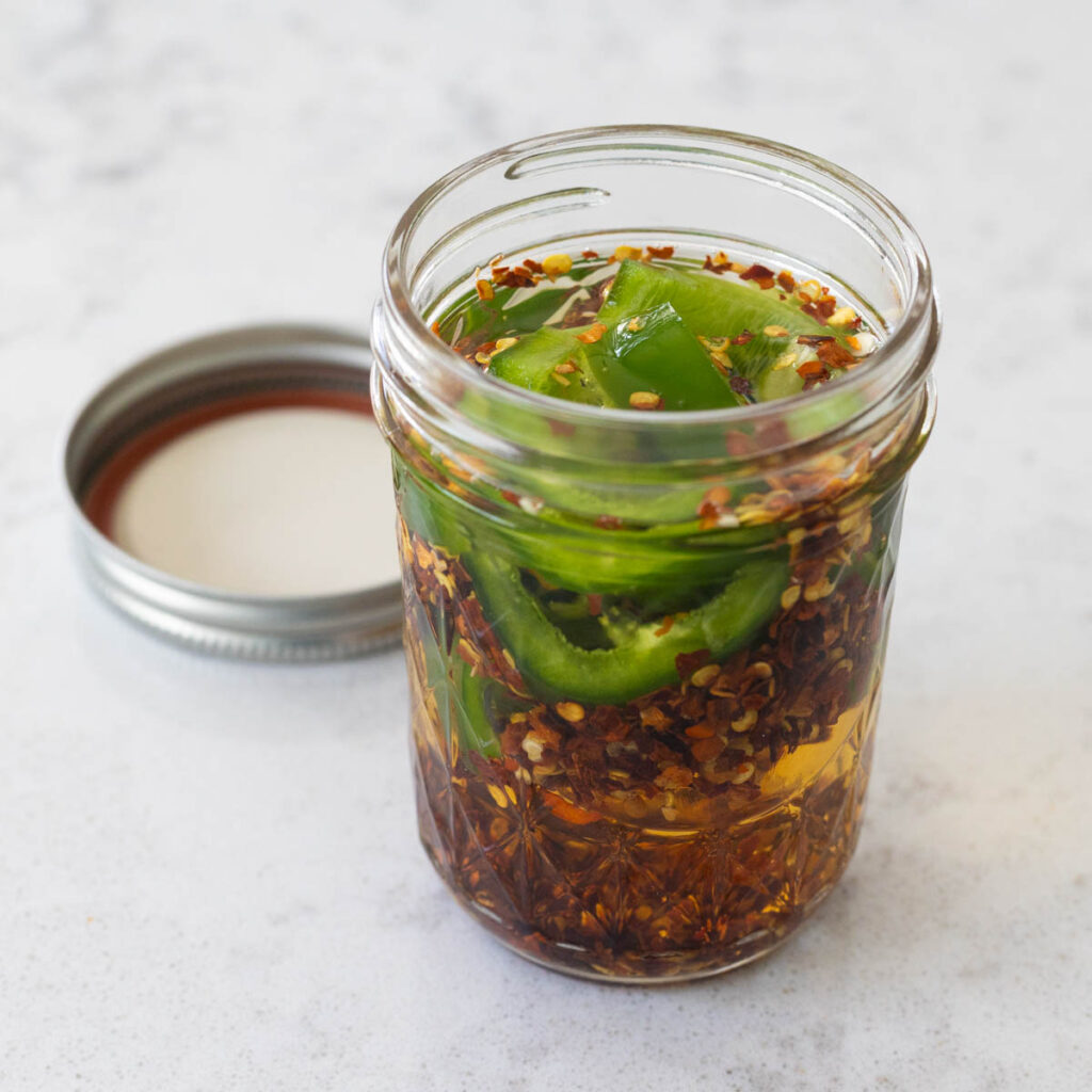 A mason jar filled with peppered vinegar.