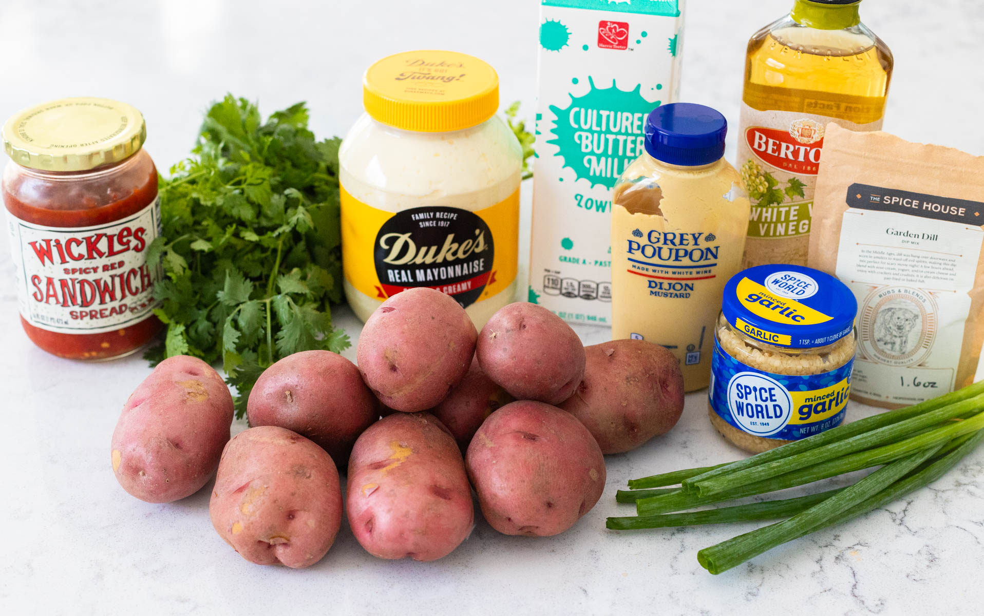 The ingredients to make the potato salad are on the kitchen counter.