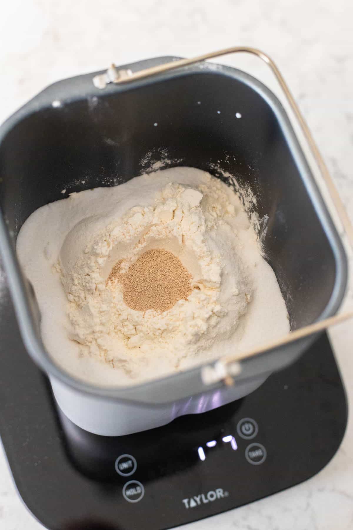 The flour and yeast have been added to the bread pan.