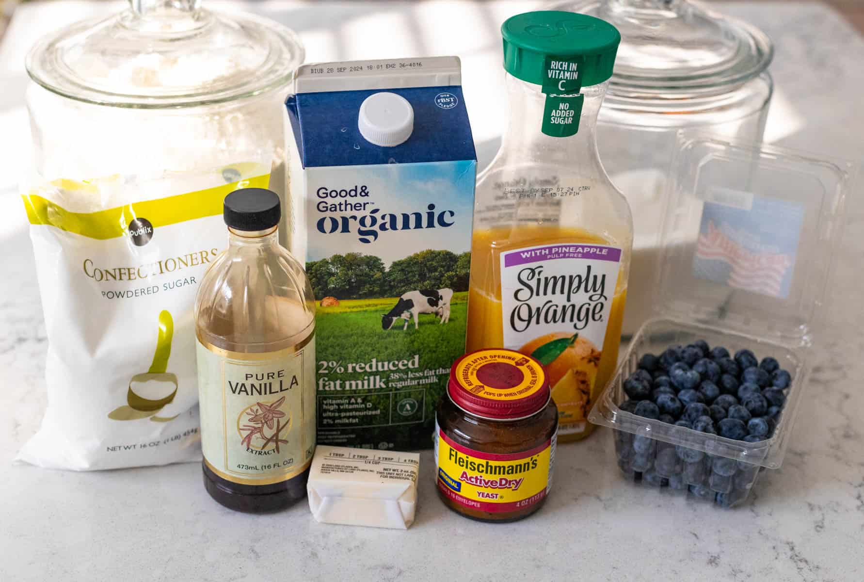 The ingredients to make homemade blueberry rolls in a bread machine are on the counter.