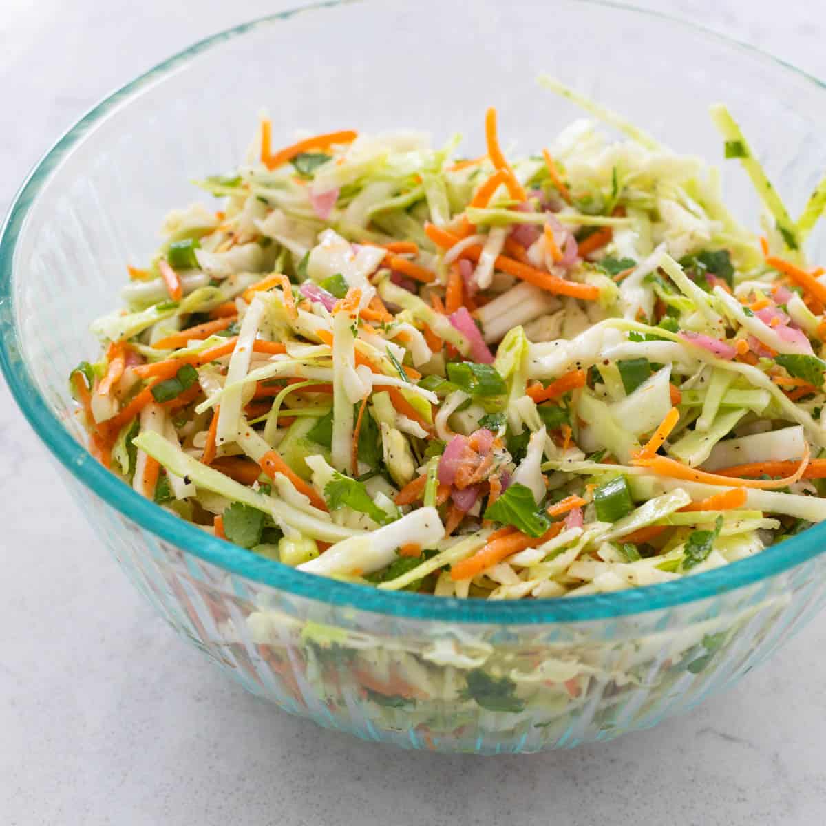 A mixing bowl filled with shredded vegetables.