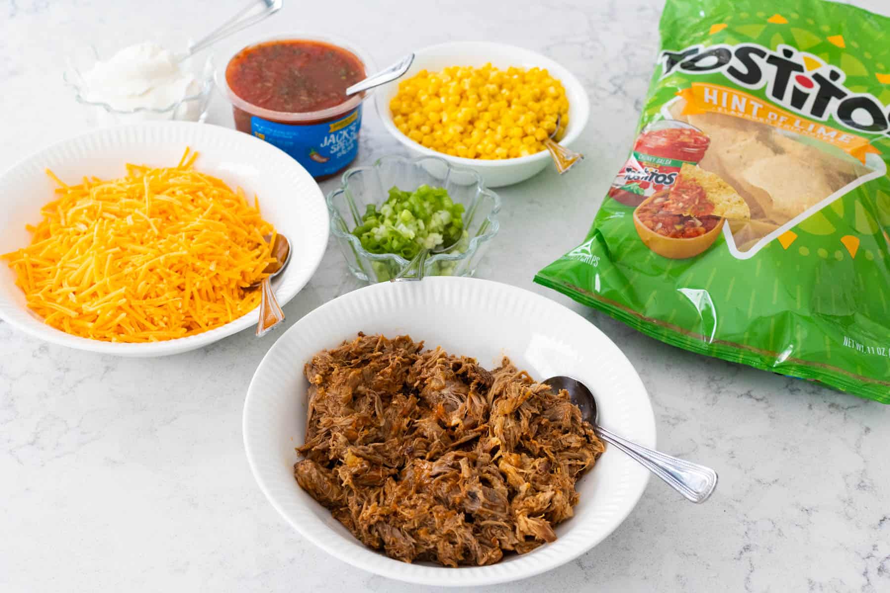 The ingredients to make a quick plate of nachos in the microwave are on the counter.