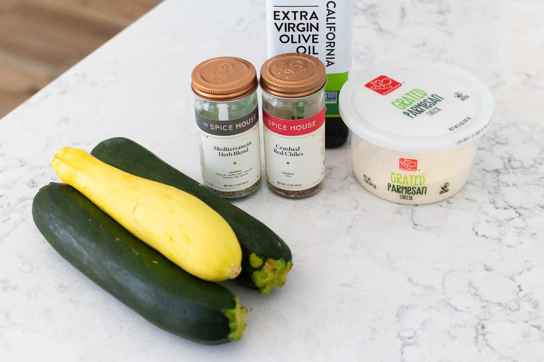 The fresh zucchini and yellow squash are on the counter next to the remaining ingredients for the recipe.