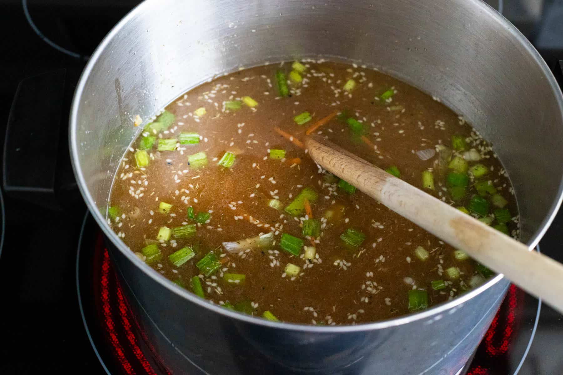 The chicken stock and soy sauce plus seasonings are now in the soup pot.