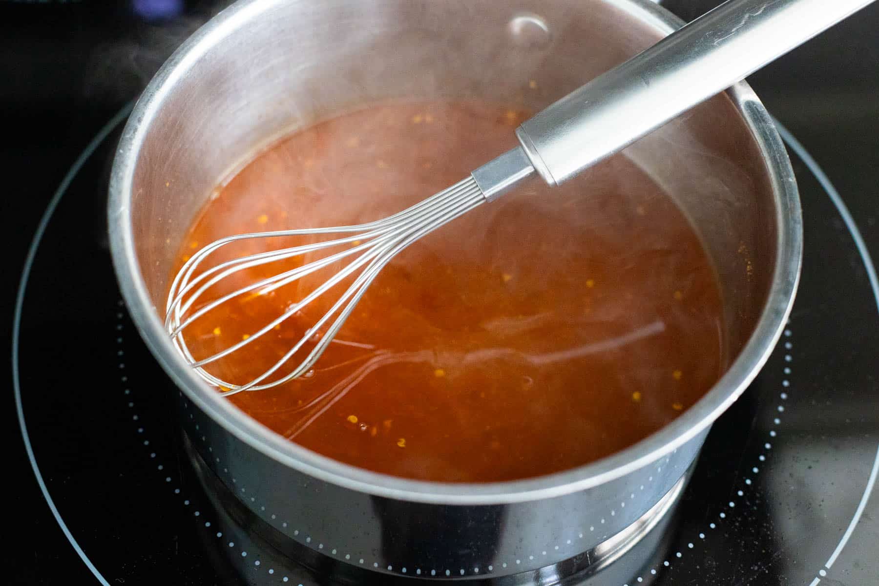 The honey and cider vinegar have been cooked with the chicken juices in the saucepan.