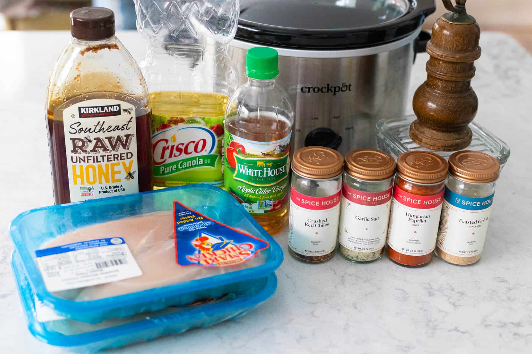 The ingredients to make the hot honey chicken are in front of the slowcooker.